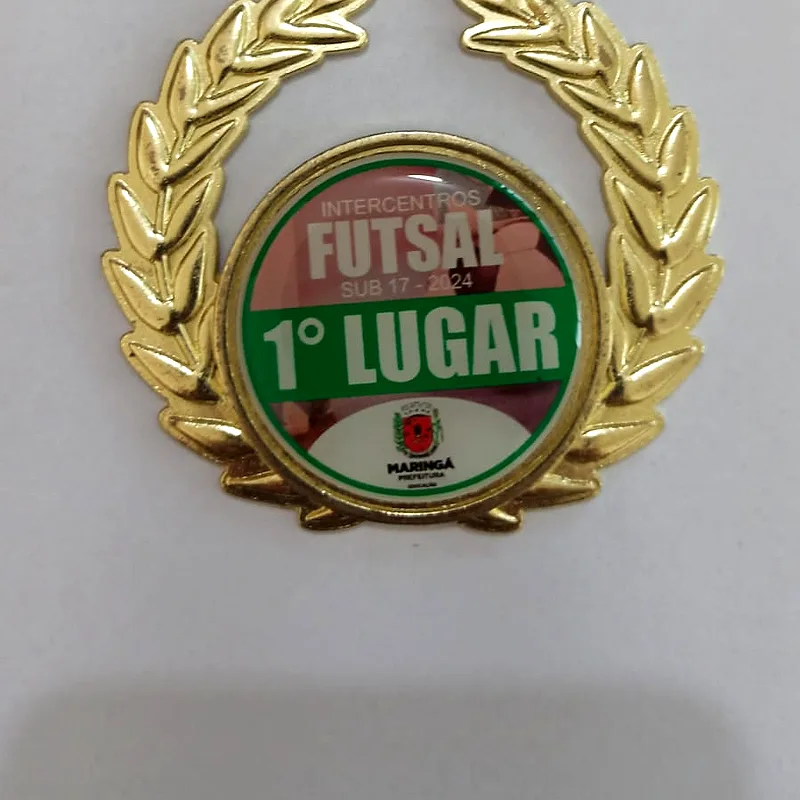 Medalha de futsal em Zamac com acabamento dourado, laurel em relevo e centro em resina colorida